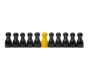 Leadership and standing out with one yellow figure in a black row