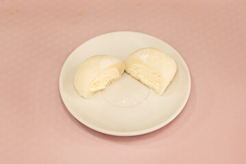 Grilled mochi (Yaki Mochi) with a lightly toasted and crispy surface, brushed with sweet soy sauce and wrapped with a strip of nori seaweed, served on a bamboo skewer