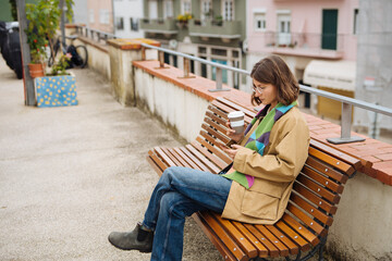 Casual friends share laughs and drinks on urban rooftop during daytime