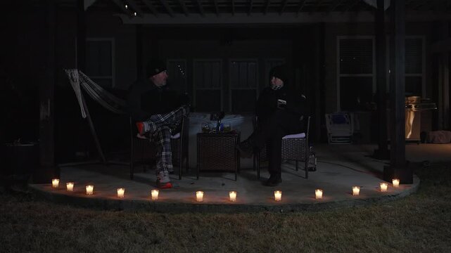 couple talking by circle of candles at dia de las velitas celebration
