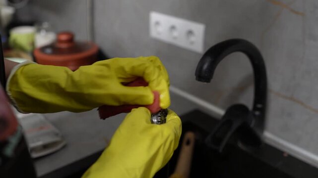 How to clean and prepare a shellfish in a kitchen setting with safety gloves