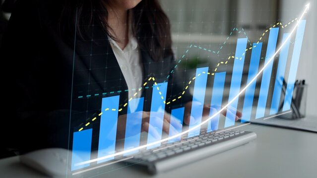 A professional woman engages with analytical data on a computer, showcasing colorful graphs and charts that signify growth and strategic insights in a modern office. Copula - Powered by Adobe