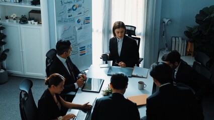 Top view of smart diverse marketing team prepare for business meeting. Professional businesspeople placed laptop and tablet with financial statistic at table. Creative business concept. Directorate.