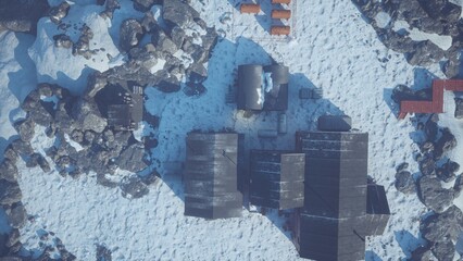A tranquil scene shows a remote settlement surrounded by snow and jagged rocks. Buildings are scattered, with the evening light casting long shadows over the icy land.