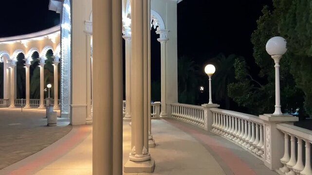 GAGRA, ABKHAZIA - JANUARY 05, 2025: Columns and marble floor of the Gagra Colonnade at sunset. A colonnade illuminated in the evening on the Black Sea coast in winter.