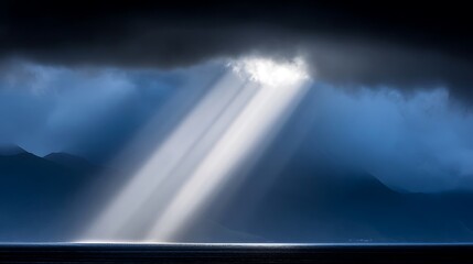 Dramatic sunbeams piercing through stormy, dark clouds, illuminating a tranquil landscape