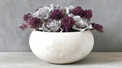 Elegant floral arrangement featuring purple and grey blooms in a spherical white vase