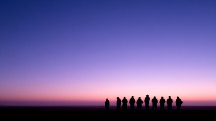 Group of people silhouetted against a vivid dusk sky of pinks and purples