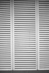 High Contrast Black and White Vertical Architectural Texture of White Wooden Louver Panels