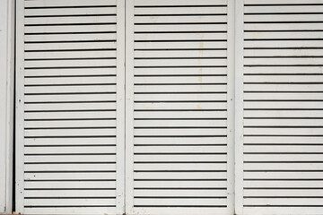 High Contrast Black and White Vertical Architectural Texture of White Wooden Louver Panels