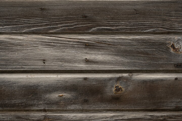 Detailed close-up of dark weathered wood texture with rustic horizontal planks and natural grain.