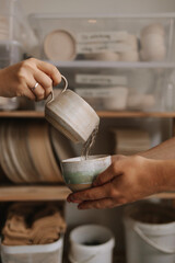 man pouring water into cup