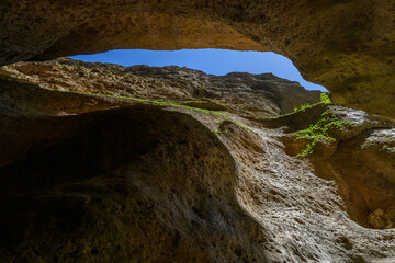 Cave Entrance with Sunlight and Blue Sky