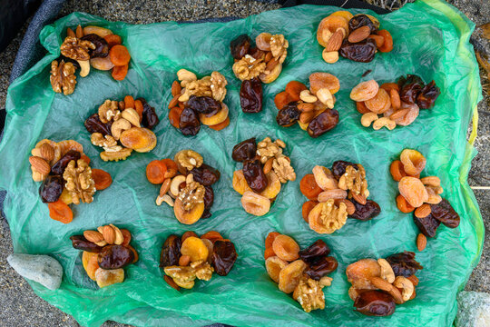 Dried fruits and nuts displayed on a green cloth in Russia's market