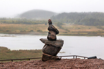 Stone Balance Tower in Serene River Landscape