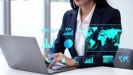 Businesswoman in a suit types on a laptop with a digital display overlay showcasing charts, graphs, and a world map in a bright office setting. - Powered by Adobe