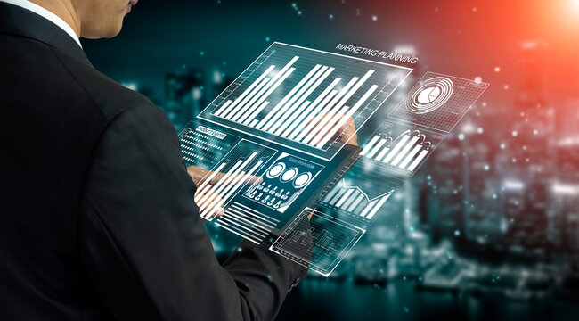 A businessman interacts with a futuristic digital interface displaying marketing data while overlooking a vibrant cityscape, embodying modern technology impact on strategic planning. Impute - Powered by Adobe