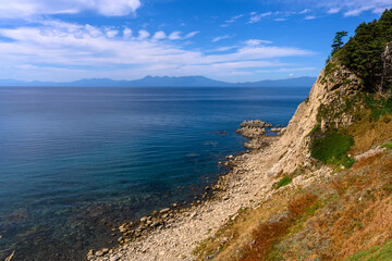 Serene coastline of Russia with calm waters and distant mountains