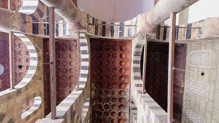 Intricate ceiling and architectural details inside a historic Egyptian mosque, highlighting traditional design during a travel visit.
