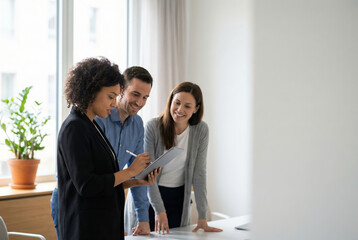 Professionals collaborating on digital tablet in office