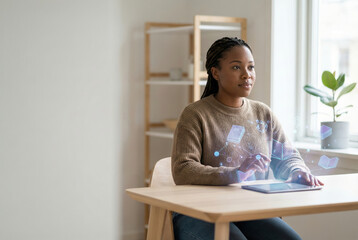 Black woman using augmented reality tablet at home