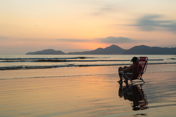 Man Relaxing on the Beach at Sunset in Santos, Brazil