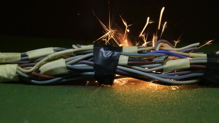 Bright sparks fly out of the damaged part of the tourniquet, local burning begins