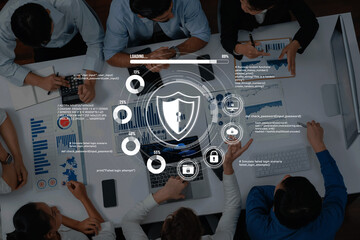 A diverse team collaborates on cybersecurity strategies, analyzing data and trends in a modern office. Focus on data protection and digital security. Trope