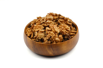 Peeled walnuts in wooden bowl isolated on white background. Top view.