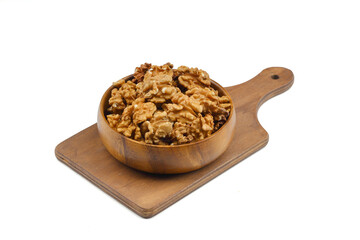 Peeled walnuts in wooden bowl isolated on white background. Top view.
