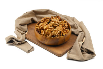 Peeled walnuts in wooden bowl isolated on white background. Top view.