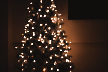 Warm, cozy Christmas tree with glowing white lights, shot with a shallow depth of field, bokeh effect. Perfect festive background for holiday designs, winter, and new year concepts. Feliz Navidad 2026