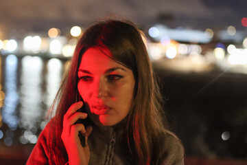 Young woman receiving urgent red light phone call