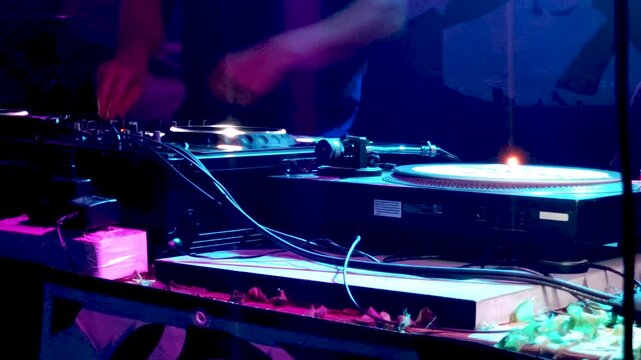 DJ Mixing Live on Stage with Turntables and Audio Gear