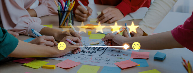 Obraz premium A dynamic group of individuals engages in a collaborative mind mapping session, using colorful sticky notes and pens to share and develop creative ideas for projects. Trope