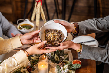 Sharing traditional Christmas kutia at holiday dinner