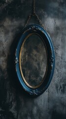 A blue oval mirror with gold trim hanging on a wall