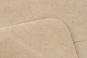 Close-up of layered recycled cardboard sheets with visible fibers and rounded edges. Natural background, eco design, handmade texture. Copy space