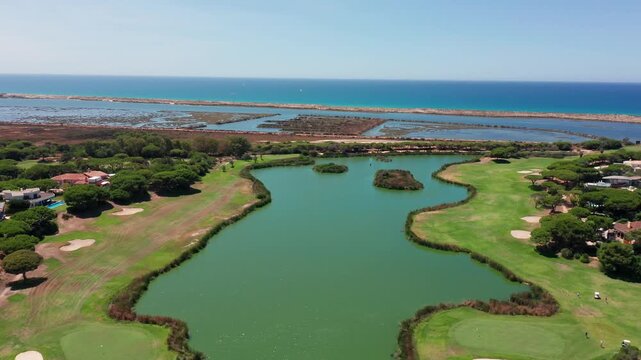 Vale de Lobo aerial coastal golf course lagoon sea overlooking vale de lobo resort in algarve portugal emerald fairways, water hazards, sand bunkers, residential villas, marsh channels,