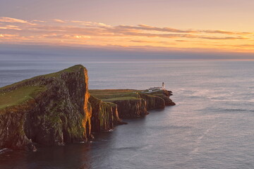 The 122m high An t-Aigeach (Stallion Head) crag and the Neist Point lighthouse, seen at sunset from the Duirinish Peninsula cliffs. Skye-Scotland-154 © rweisswald