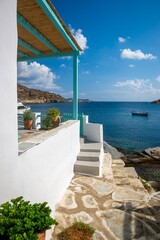 Obraz premium View down a typical traditional alleyway out to the sea in the rustic sugar cube village of Faros on the greek island of Sifnos.