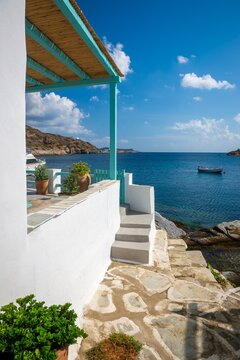 View down a typical traditional alleyway out to the sea in the rustic sugar cube village of Faros on the greek island of Sifnos.