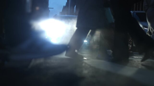 Slow motion low angle view showing pedestrians crossing street in New York City, USA. Cold winter street scene with people waking in NYC.