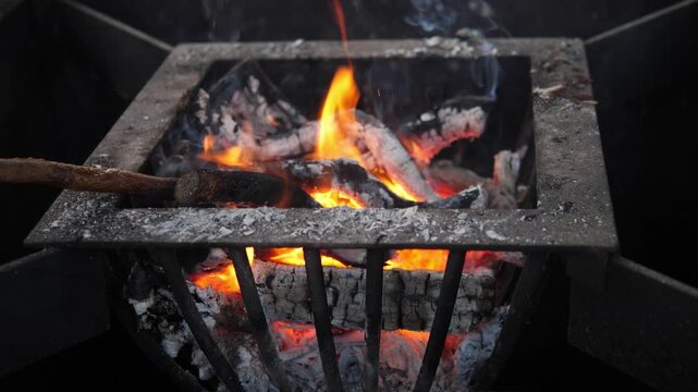 A small open fire at a Christmas market. The glowing flames create a cozy contrast to the cold winter atmosphere surrounding the festive outdoor event