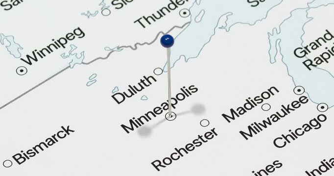 A zoom out of a blue pin into a Minneapolis city of The United States of America political map