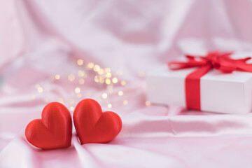 Romantic hearts and gift box on soft pink bokeh, cozy scene