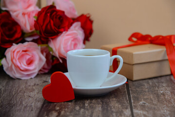 A red heart and a cup of coffee on the table, Valentine's Day