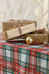 Craft gift boxes on red green plaid tablecloth