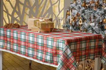Red green plaid tablecloth with wrapped gift boxes