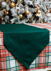 Green triangle table runner on plaid Christmas table